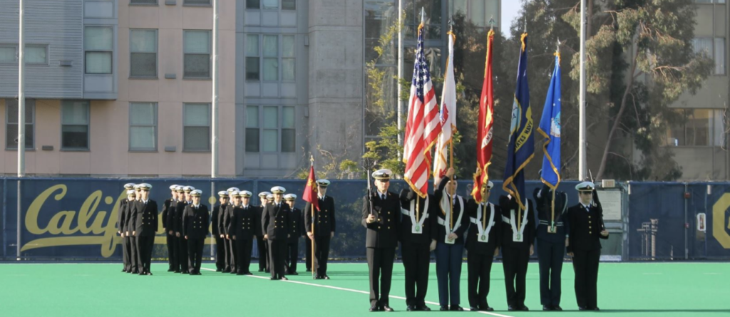 Midshipmen on field performing flag color guard activities